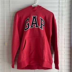 The brand is Gap. It is light red with a navy font. It’s a size 14 - 16.